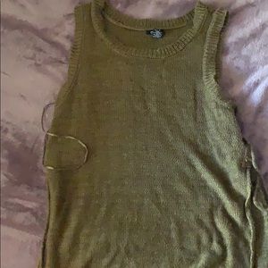 A green sleeveless shirt with slits on the side.